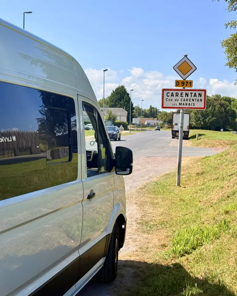 A campervan on an open road near Carentan