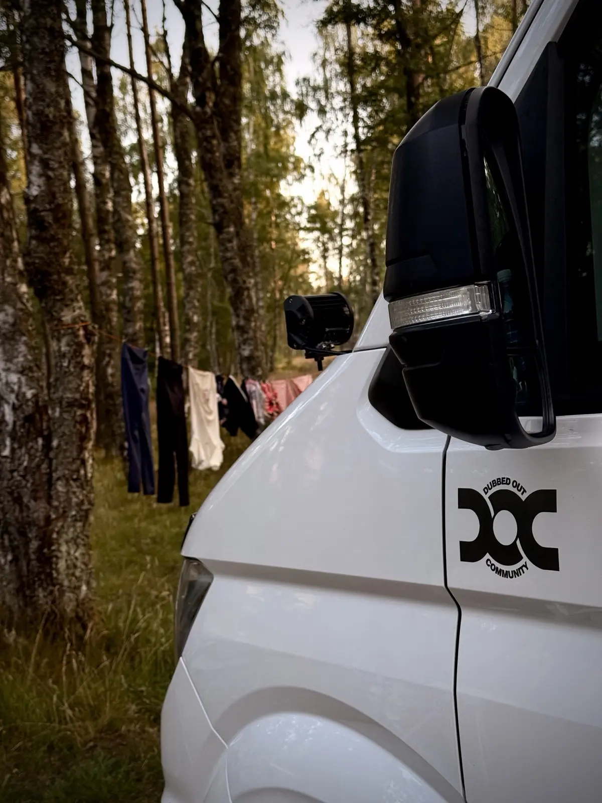 The campervan parked among birch trees at Glen Feshie, washing on a line strung between the trunks
